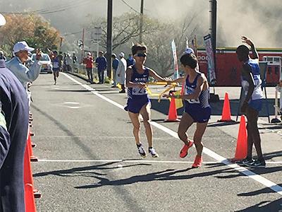 Sash being passed from the first leg runner to the second