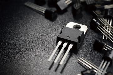 A semiconductor wafer and manufactured transistors (rendered image)