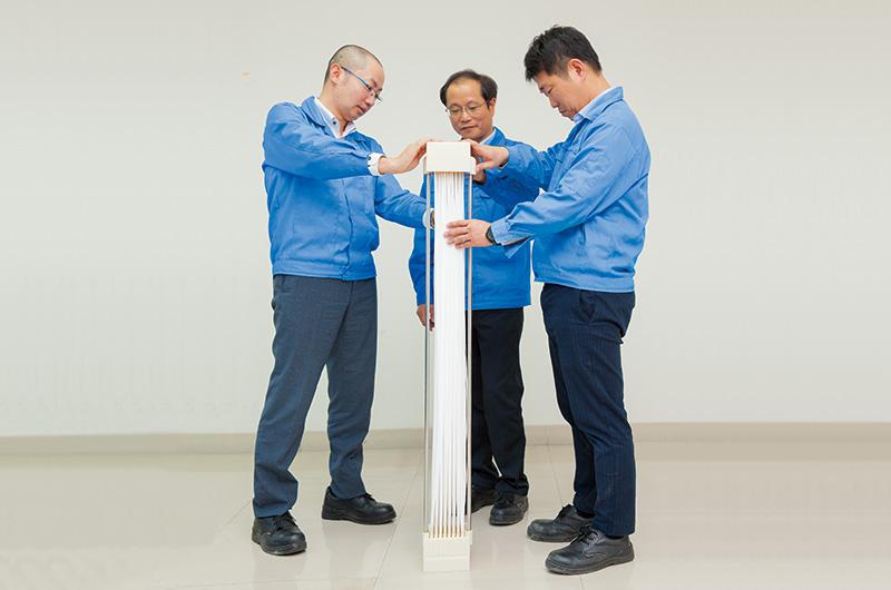 Engineering staff thoroughly checking a completed POREFLON™ module